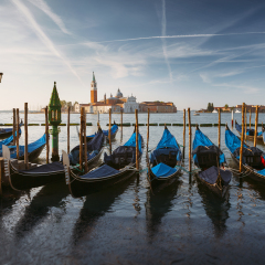 Gondolas and campanile in Venice lagoon, Italy