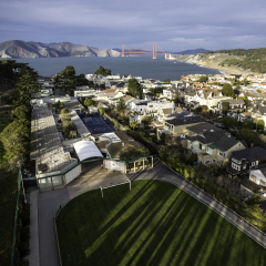 Unique view from the treetops over San Francisco's Lincoln Park looking over Presidio Heights, Baker Beach, and towards the Golden Gate Bridge