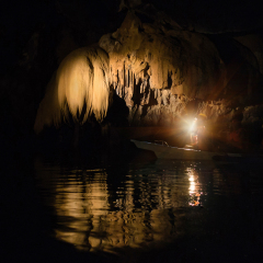 Unique image of Puerto Princesa subterranean underground river from inside - Adventurous trip in exclusive Philippines destinations - Dark lighting with the real feeling from visitor's point of view