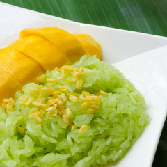Colorful native Thai style dessert, Mango with sticky rice, garnish with roasted green beans.