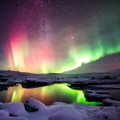 A beautiful green and red aurora dancing over the Jokulsarlon lagoon, Iceland