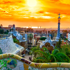View of the city from Park Guell in Barcelona, Spain with sunrise colors.