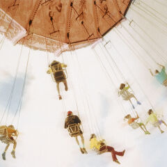 People on an amusement park swing