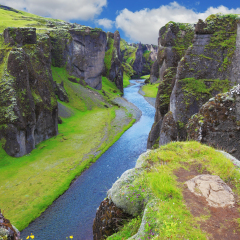 Neverland Iceland. The picturesque canyon Fjadrargljufur, green cliffs and blue water of the river
