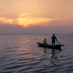 Fishers rowing a boat in Dianshan Lake, which is the source of Huangpu River, the famous river flows through Shanghai City.