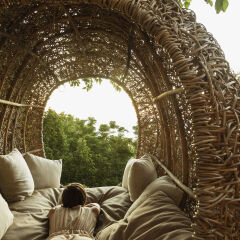 Woman laying in nest tree house