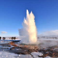 Geyser Park in Iceland. Stokkur eruption with sunstar in a beautiful sunny day in winter.