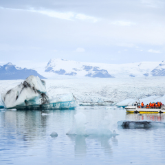 Tourists on amphibious vehicle taking a cruise around the Jokulsarlon glacier lake, where icebergs melting from the Vatnajokull glacier and float out to the Atlantic ocean