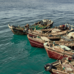 Shandong sunny old wooden fishing boat floating in the Sunshine Coast