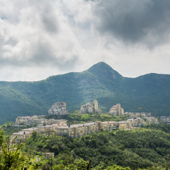 Modern castles on the top of mountain against cloudy sky in Overseas Chinese Town East  (OCT East ) in Shenzhen, Guangdong, China.