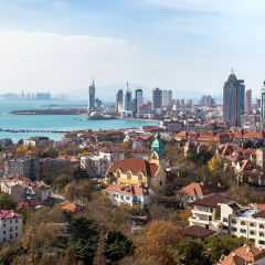 Qingdao Bay and the Lutheran church seen from the hill of Signal Park in Autumn, Qingdao, China