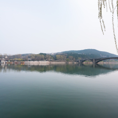 travel to China - view of Yi river and East Hill of Chinese Buddhist monument Longmen Grottoes (Dragon's Gate Grottoes, Longmen Caves) in spring season