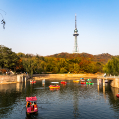 Small pond with boats in Zhongshan Park in Autumn, Qingdao, China