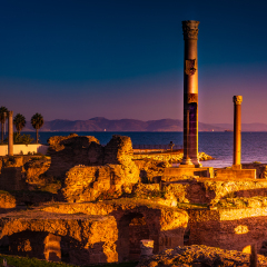 Ancient ruins at Carthage, Tunisia with the Mediterranean Sea in distance. Dramatic sunset light.