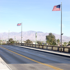 The replica of Robert P. McCulloch London Bridge in Lake Havasu City with waving British and American flags / London Bridge California           