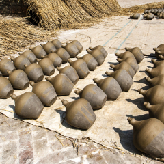Clay pots (jars) drying in the sun on pottery square in Bhaktapur in Nepal - Asia