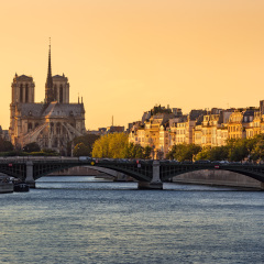 Notre Dame de Paris Cathedral, Ile Saint Louis, the Sully Bridge, and the Seine River at sunset in Summer. 4th Arrondissement of Paris. France