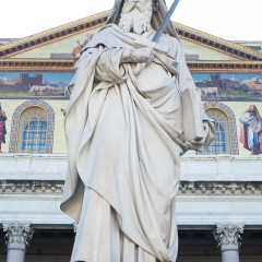 St Paul holding a sword statue outside basilica in Rome, Italy
