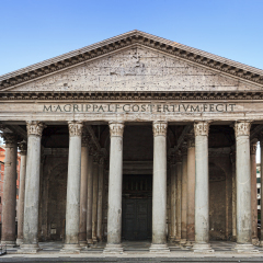 Facade colonnade and entrance to ancient roman temple Pantheon. City square in a heart of Italian roman capital with nobody around.