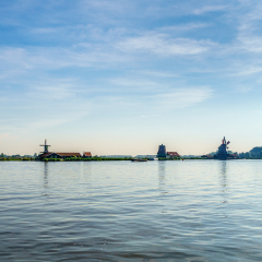 View from the Zaan River of Dutch Windmills and Historic Houses at the old fishing villages of Zaanse Schans and Zaandijk in the Netherlands