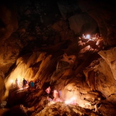One of the largest and most visited caves in Asia with smeared silhouettes of travelers people walking through the main cave center