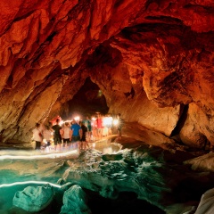 One of the largest and most visited caves in Asia with smeared silhouettes of travelers people walking through the main cave center