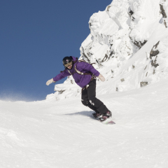 Female snowboarder in Steep Rocky Terrain