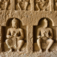 Crumbling Stone Statues at Kanheri Caves in Mumbai, India.