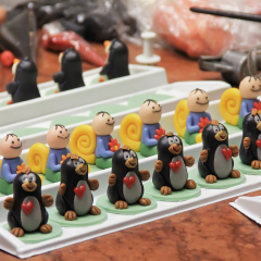 figures of marzipan modeling, preparation of sweet decorations for cakes and pies, women's hands, marzipan museum, , soft focus