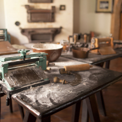 An old manual dough roller with other baker's tools in a pastry shop (in the museum of gingerbread ("pierniki"), claim of fame of polish city of Torun).