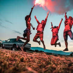 Young friends enjoying the freedom on a Car Trip over a country offroad