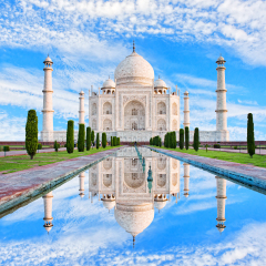 Amazing view on the Taj Mahal in sun light with reflection in water. The Taj Mahal is an ivory-white marble mausoleum on the south bank of the Yamuna river. Agra, Uttar Pradesh, India. 