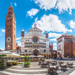 Ancient Cathedral of Cremona with famous Torrazzo bell tower and baptistery at beautiful market square Piazza Duomo in Cremona, Lombardy, Italy