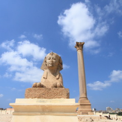 ancient Sphinx statue and Pompey's pillar in Alexandria, Egypt
