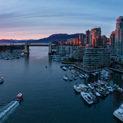 Aerial Panoramic View of Downtown Vancouver, BC, Canada around Granville Island Public Market and False Creek. Taken during a cloudy sunset.