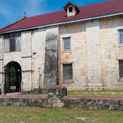 exterior of the Baclayon church on Bohol, Philippines. You can see the face of St. Padre Pio on the wall.