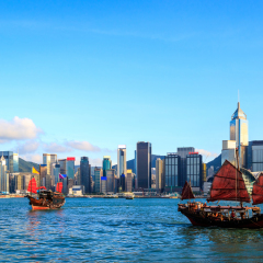 Hong Kong skyline cityscape, Tourist junk boat at Victoria Harbor in evening