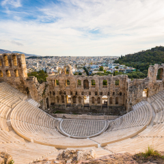 Odeon of Herodes Atticus on Acropolis hill in Athens, Greece with view on the city, sunset light and soft focus