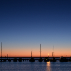 Yachts and Motor boats moor peacefully in Port Denison, Western Australia under another glorious sunset