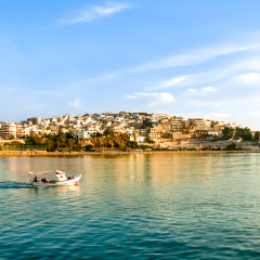 Fisherman go fishing with a small wooden boat at sunrise. Kastela,marina Zeas,Piraeus,Greece