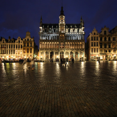 Famous building: Maison du Roi (The King's House or Het Broodhuis) in Brussels, Belgium. Located on Grote Markt (Main Square). Rainy evening, wet cobble stones.