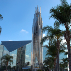 Blue skies and white clouds reflecting in the Crystal Cathedral