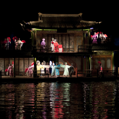 HANGZHOU, CHINA - NOVEMBER 26: A cast performs Zhang Yimou's outdoor folk musical show 'Impressions West Lake' in an outdoor stage built on the lake on November 26, 2011 in West Lake, Hangzhou, China.