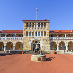 Perth Mint building, one of three branches as part of the Royal Australian Mint. Limestone building built in 1899. Facade with a statue of prospectors striking gold.