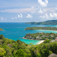 Beautiful turquoise ocean waves with boats and coastline from high view point. Kata and Karon beaches Phuket Thailand