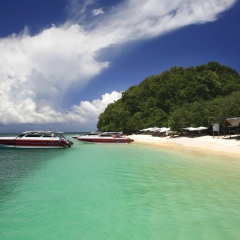 A sunny day with speed boats and a beautiful location Koh Khai Nai island near the coast of Phuket Thailand.