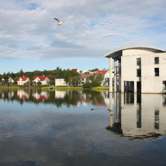 City Hall in Reykjavik, Iceland. Lake Tjorning reflection. Modern architecture.