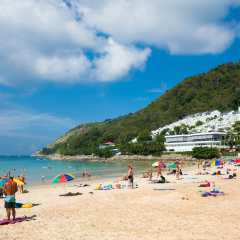 Tourists on the Nai Harn beach - one of the best beaches in Phuket, Thailand 