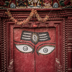 Wooden door with eyes at king palace museum on Durbar square in Kathmandu, Nepal, Wooden door with sacred eyes. Nepal before the earthquake.