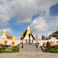 King Rama I statue and temple against blue sky at wat Yannawa in Bangkok, Thailand